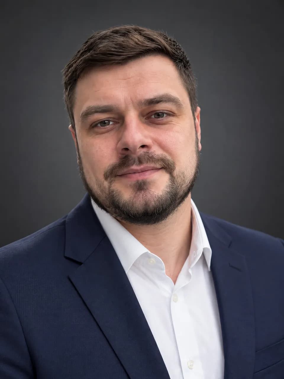 Деловой портрет мужчины с бородой в тёмно-синем пиджаке по селфи